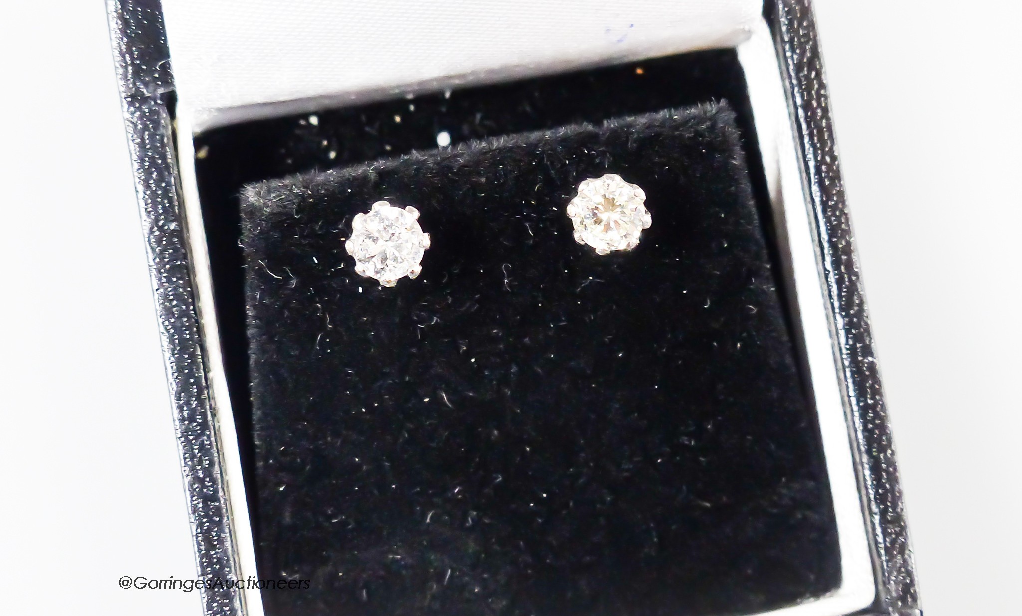 A pair of modern 18ct and solitaire diamond set ear studs, the stones each weighing approximately 0.30ct, gross weight 1.6 grams.